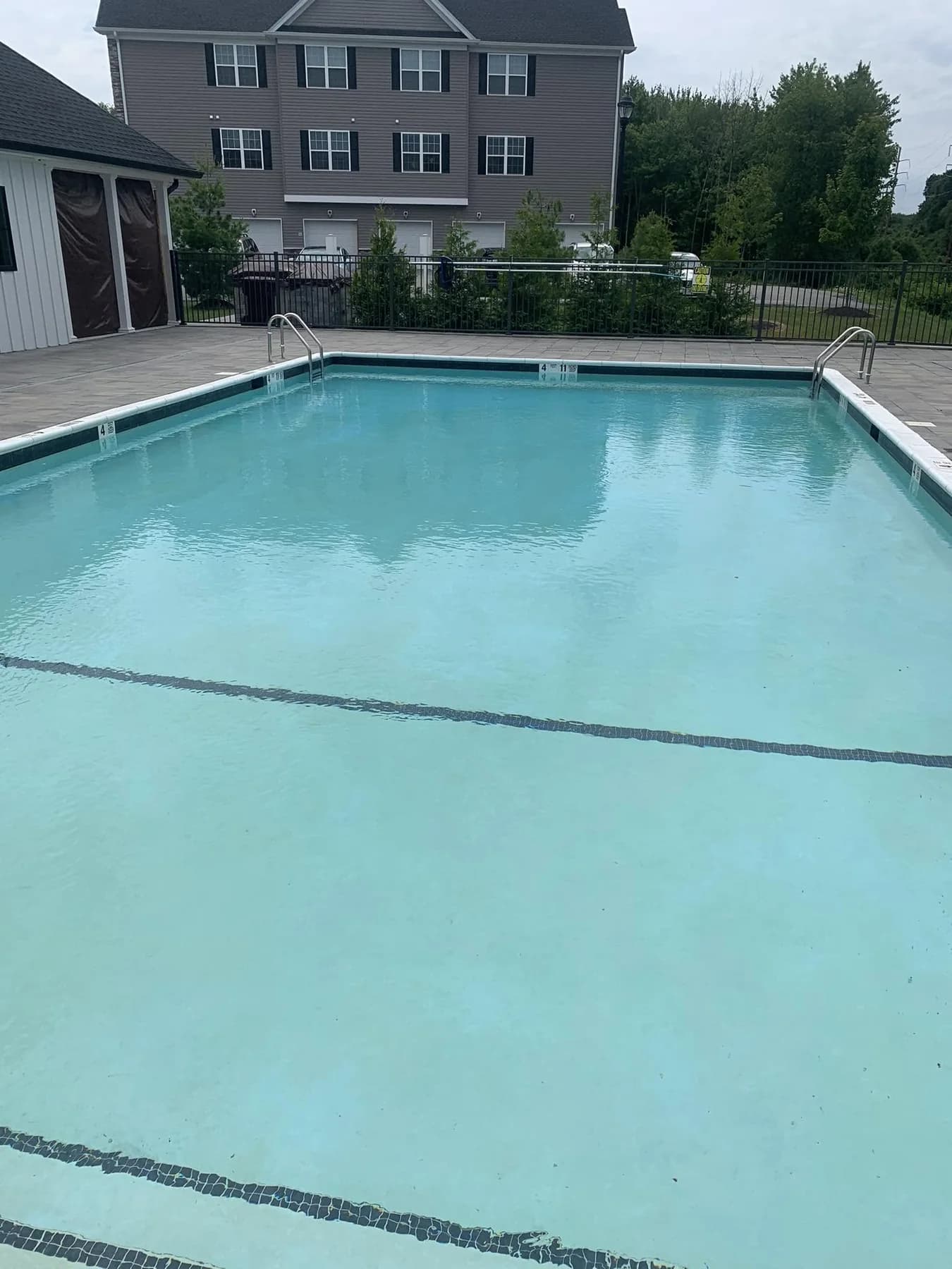 Clear swimming pool maintained by Koby Pools